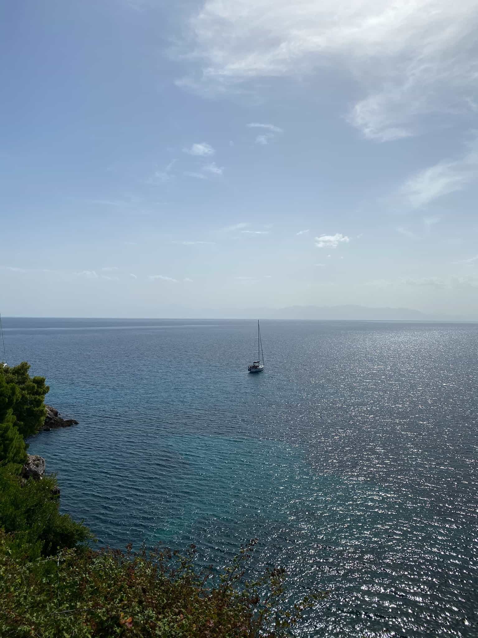 A little boat floats off the coast of Skopelos