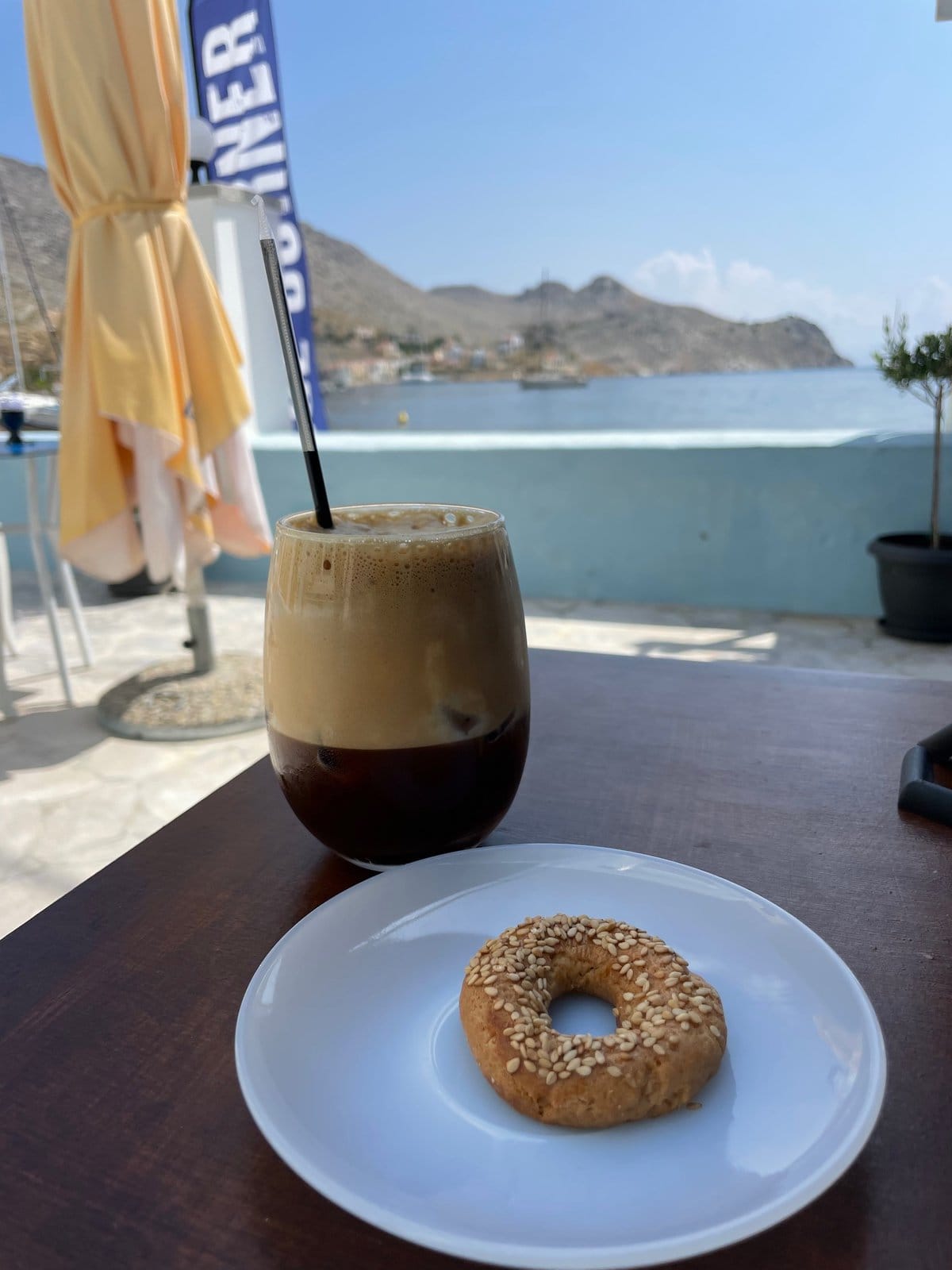 Greek Freddo espresso coffee and a koulouri by the sea