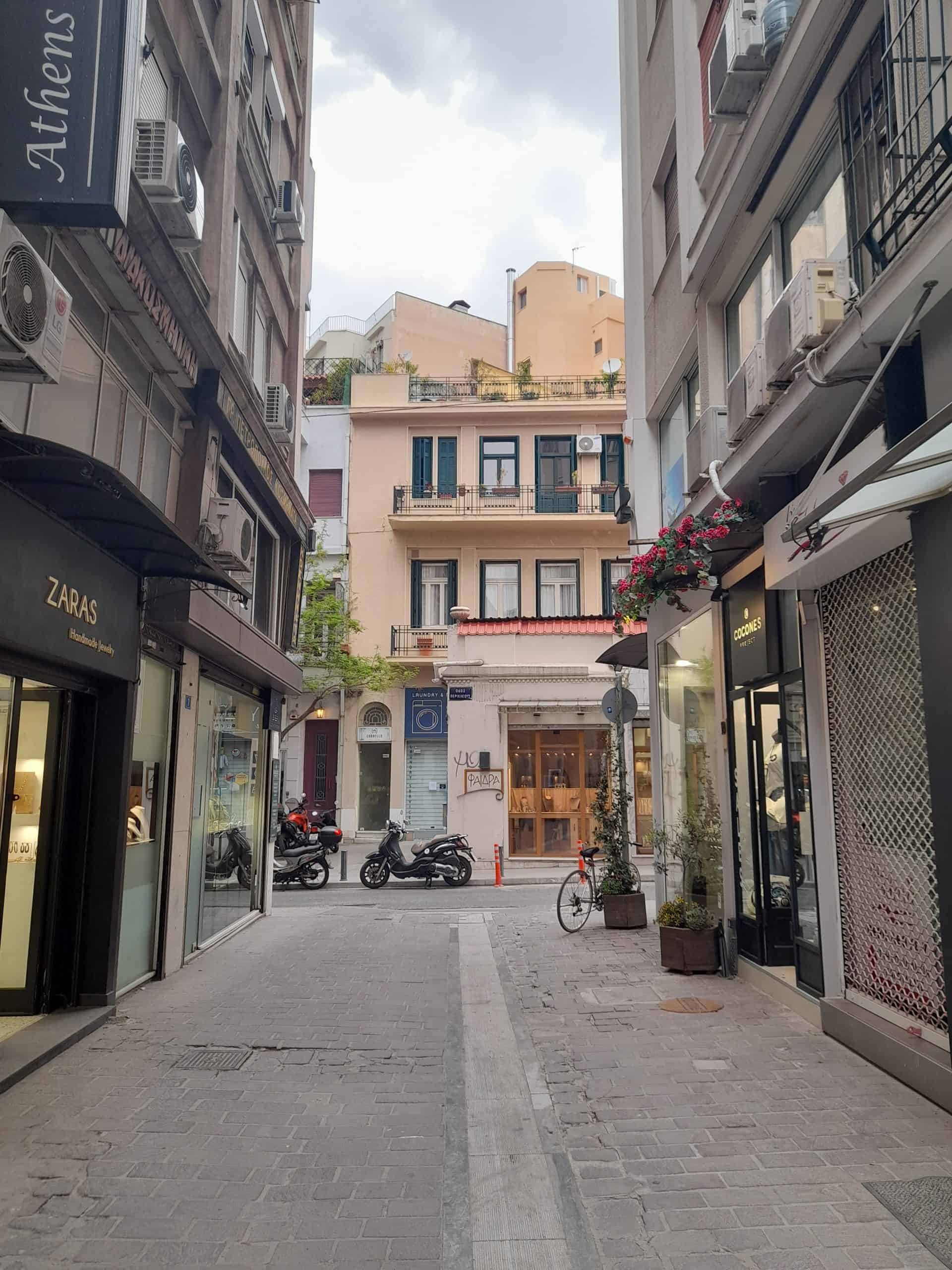 A view of an Athens street with a bike parked in the middle