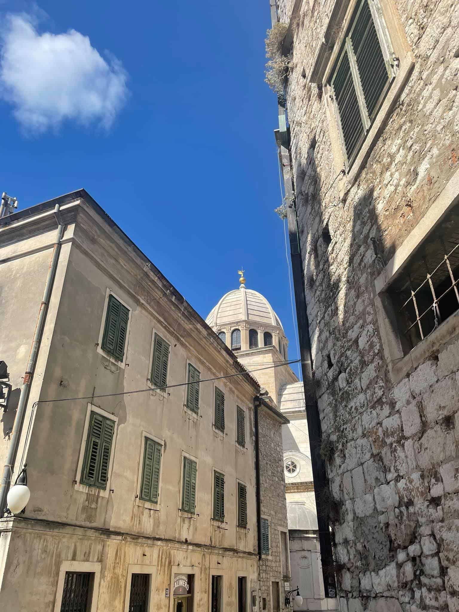 A quaint narrow street lined with a church