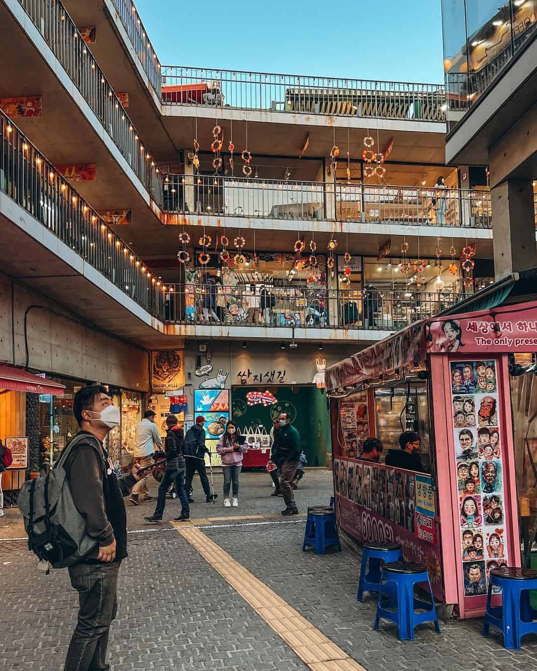 People walking along a busy street in Korea
