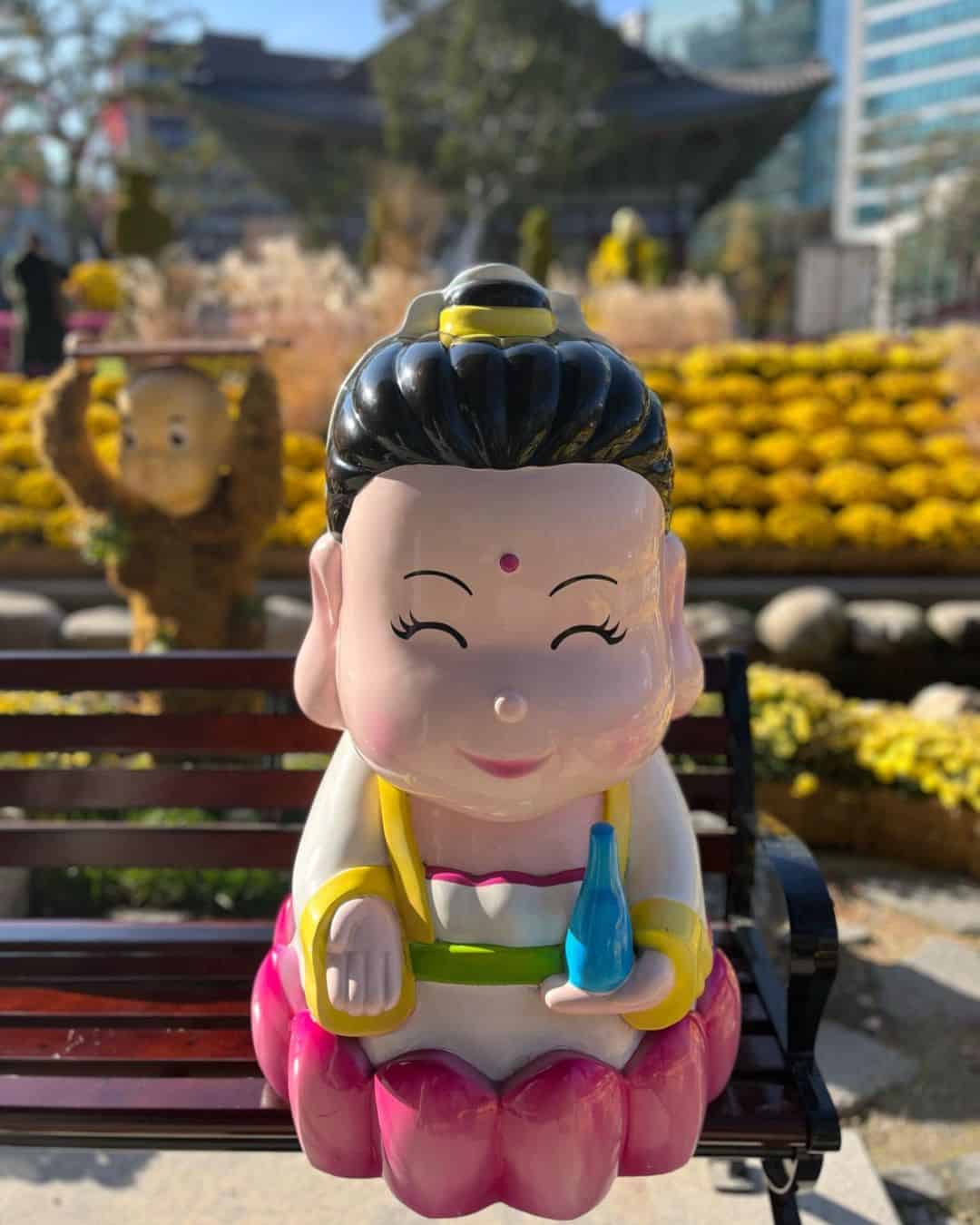 A ceramic statue of a woman carrying a glass