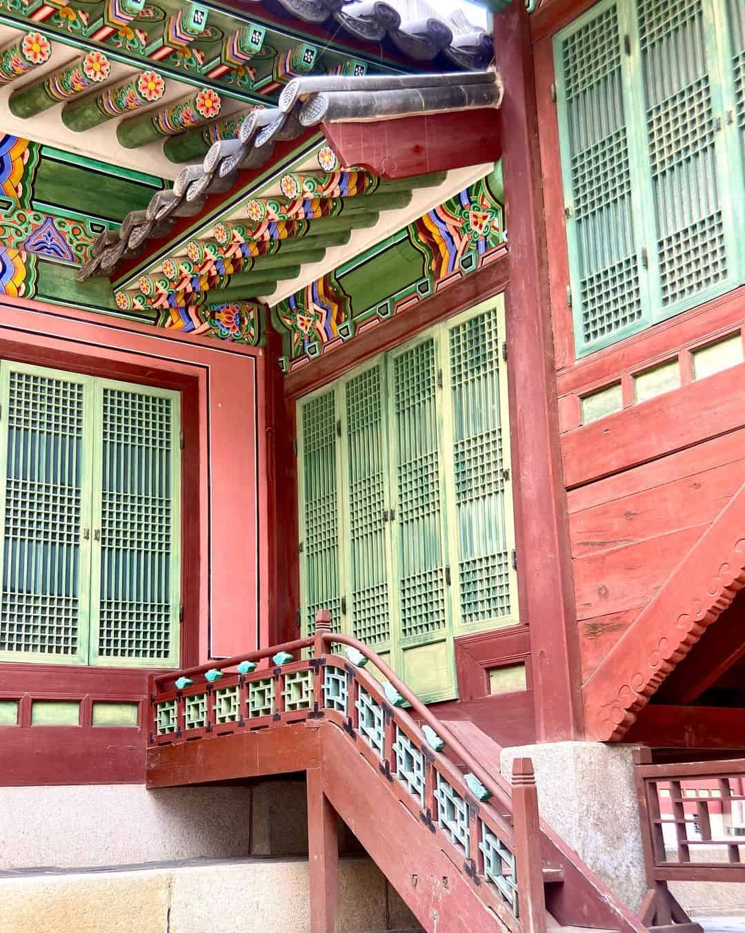 A traditional house adorned with a striking red and green pattern