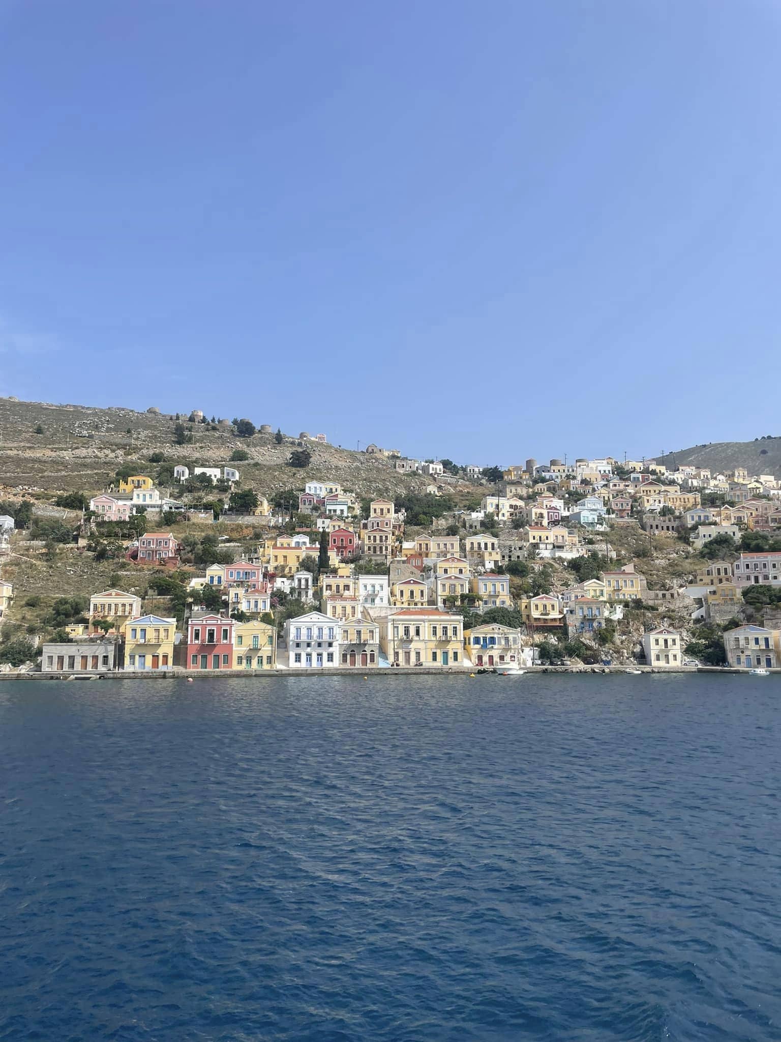 The windmills await on a hill above Symi town